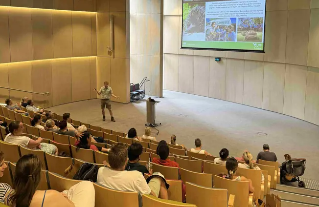 Teachers attending an education presentation in a lecture theatre.