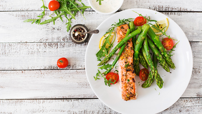 Farmed seafood - salmon with salad on a plate.