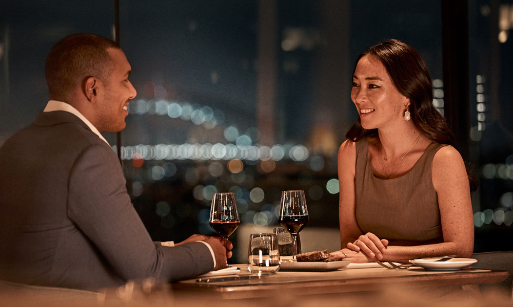 Couple dining at Me-Gal restaurant at night at the Wildlife Retreat at Taronga.